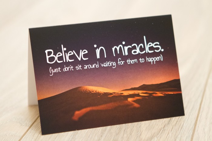Sand dunes at night with 'Believe In Miracles. Just Don't Sit Around Waiting For Them To Happen' quote