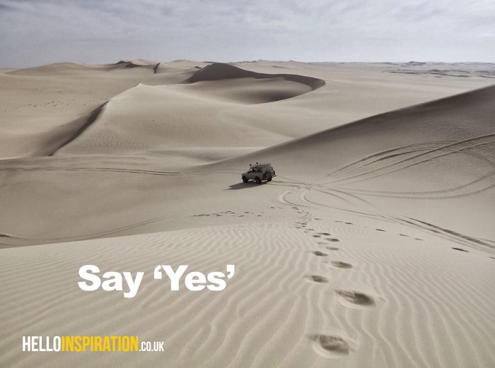Inspirational image of a 4x4 traversing sand dunes with the quote 'Say Yes'