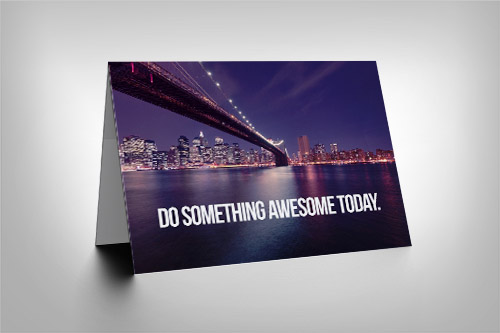 Cityscape with bridge over river with 'Do Something Awesome Today' quote