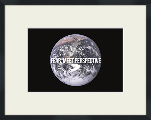 The Earth seen from space with 'Fear, Meet Perspective' quote