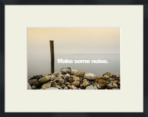 A quiet waterside scene with Make Some Noise'' quote