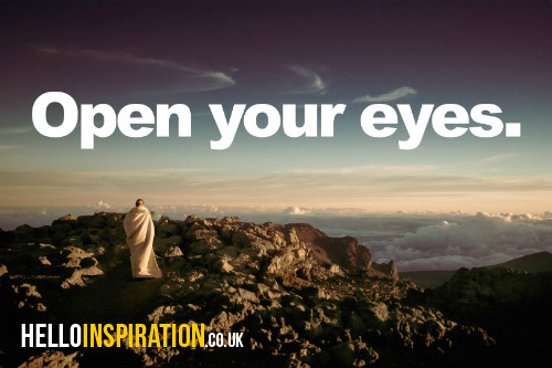 Lone figure in white on a mountain top with 'Open Your Eyes' quote