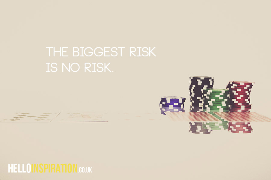 Playing cards and poker chips with 'The Biggest Risk Is No Risk' quote